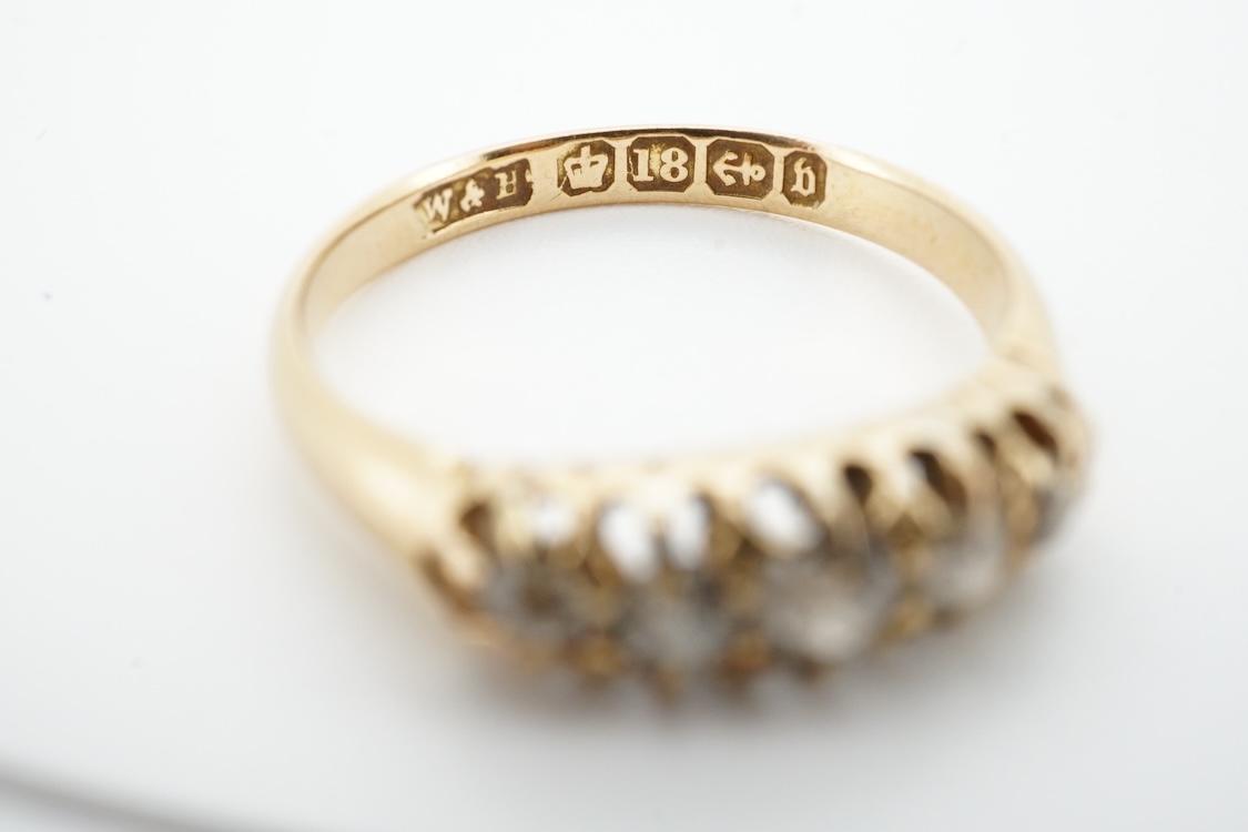 A late Victorian 18ct gold and graduated claw set five stone diamond ring, size N, gross weight 2.8 grams.
